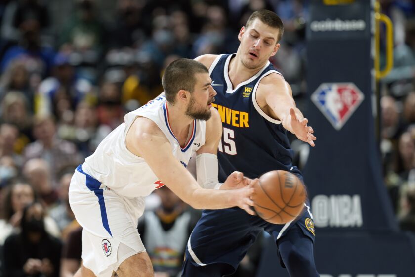 Los Angeles Clippers center Ivica Zubac, front, passes the ball as Denver Nuggets center Nikola Jokic.