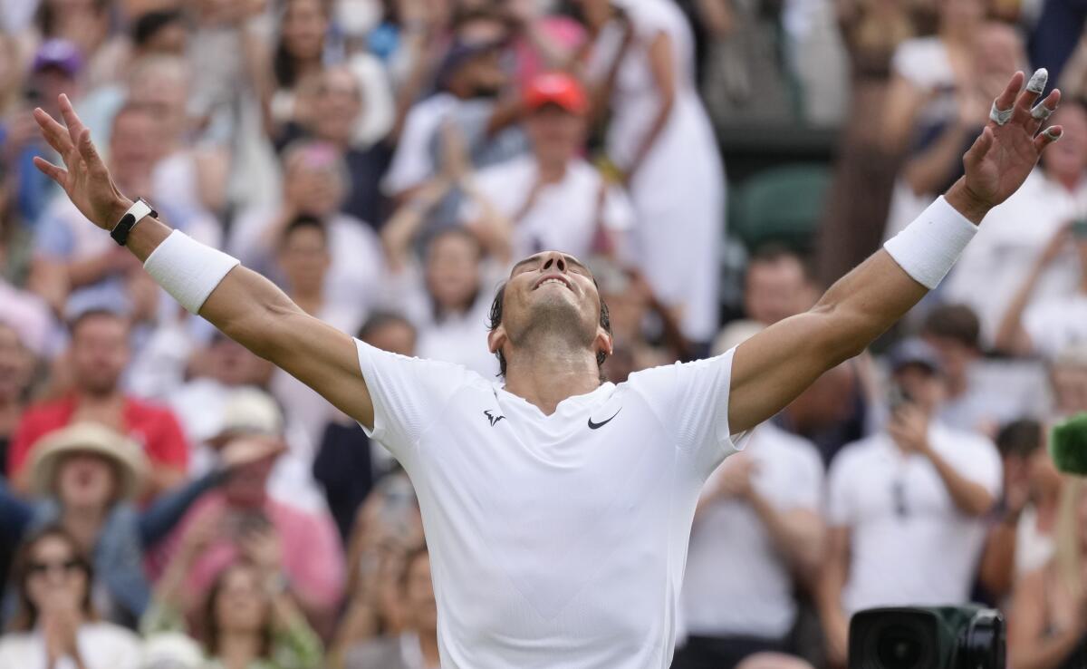 Spain's Rafael Nadal celebrates quarterfinal with arms outstretched and face lifted to the sky