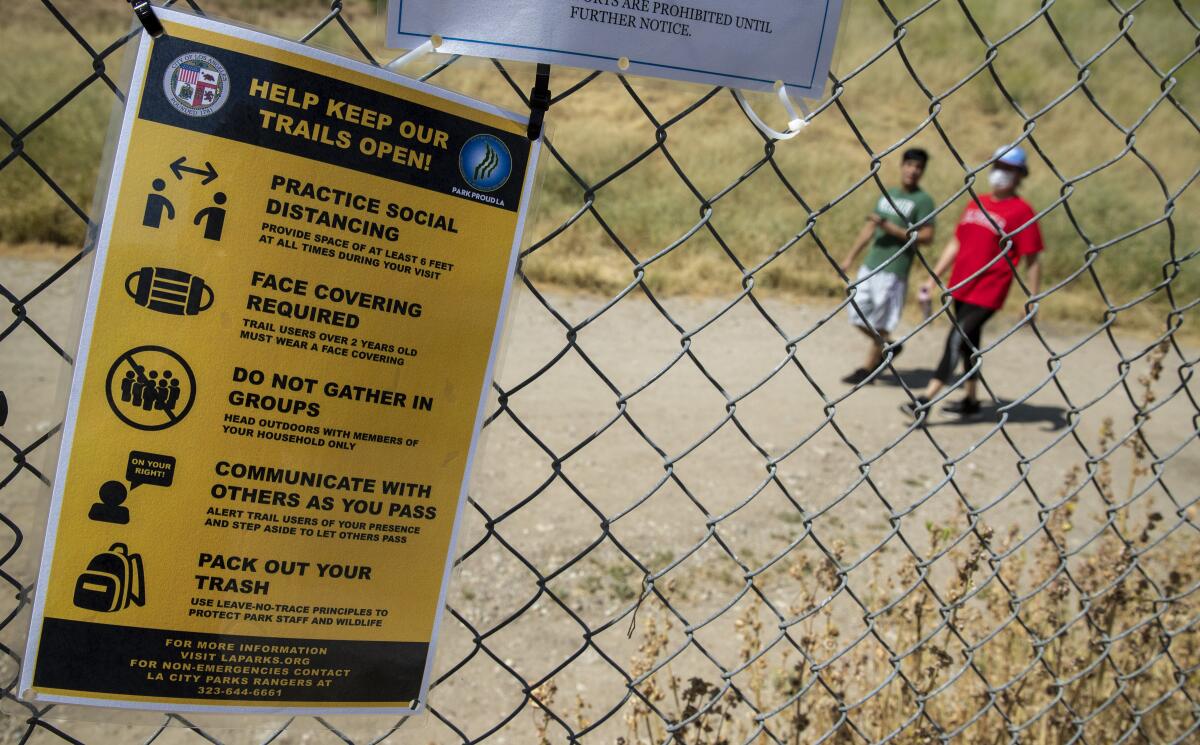 Hikers at El Scorpion Park take advantage of newly reopened trails on Saturday in West Hills.