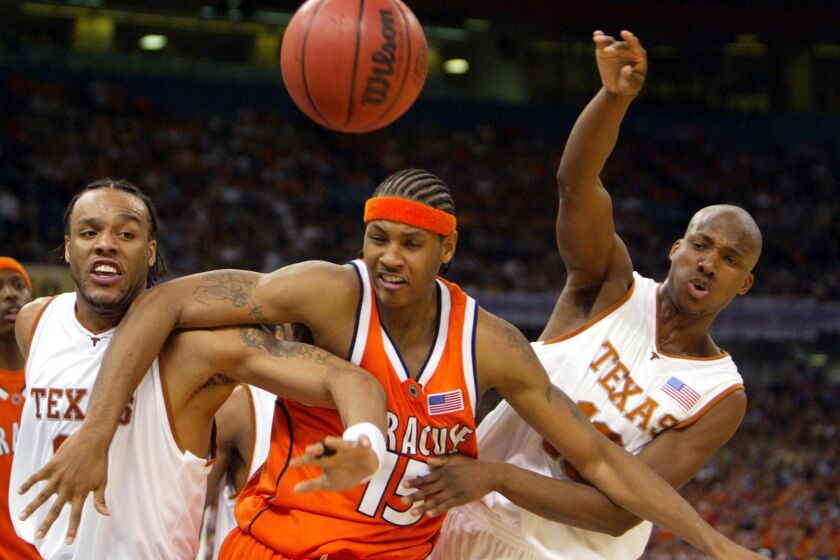 Carmelo Anthony fights for rebounding position against Texas' James Thomas, left, and Sydmill Harris during Syracuse's Final Four victory on April 5, 2003, in New Orleans.