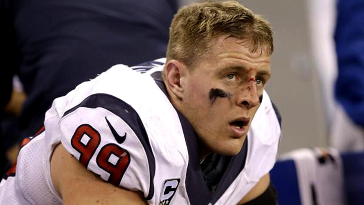 Texans defensive end J.J. Watt, bloody nose and all, sits on the bench during the second half of a game against the Colts in Indianapolis.