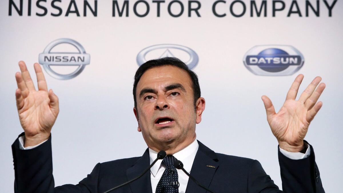 In this photo taken on Nov. 1, 2013, Carlos Ghosn, then president of Japan's auto giant Nissan Motor Co., announces the company's first-half financial results at the automaker's headquarters in Yokohama, suburban Tokyo.
