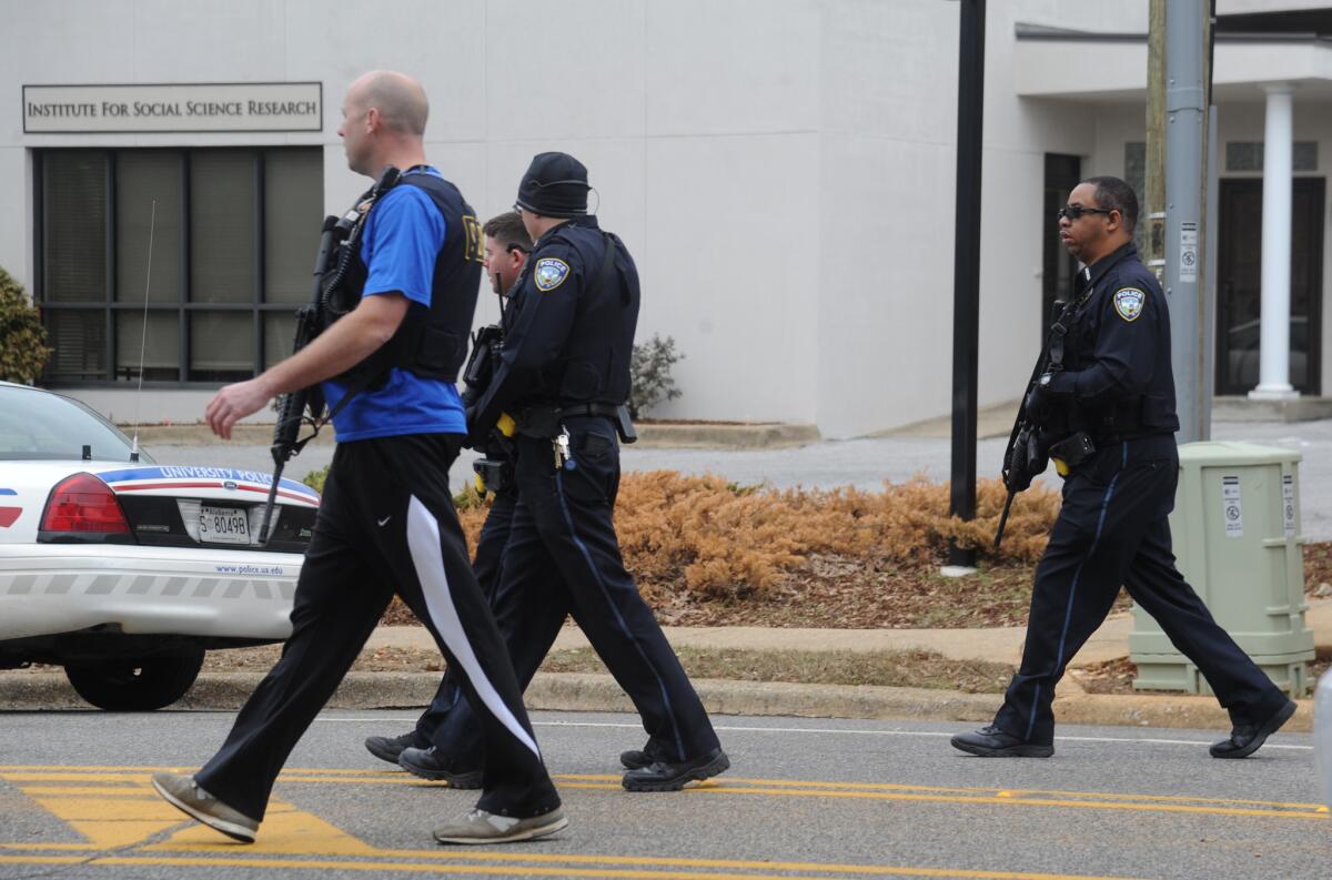 Law enforcement officers move into position outside the the Alabama Credit Union in Tuscaloosa after reports of a hostage standoff on Jan. 10, 2017.