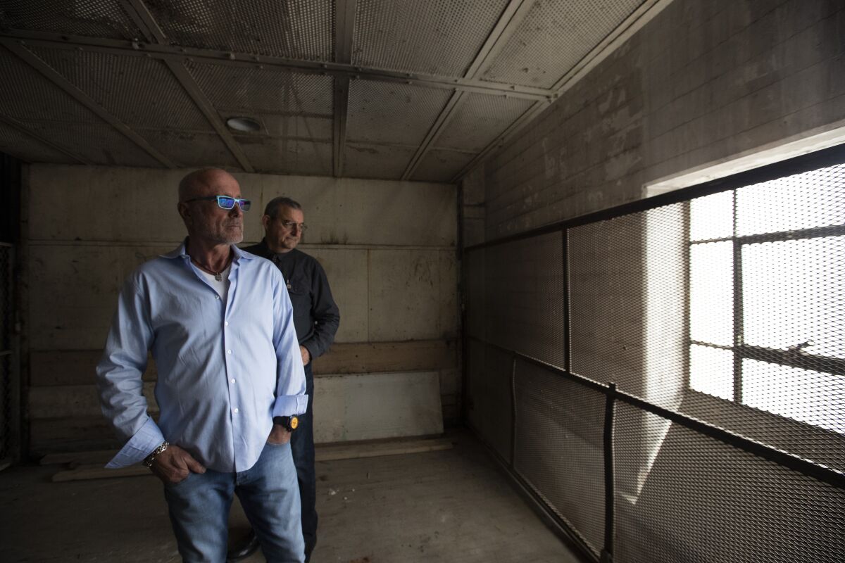 Two men in a freigh elevator inside the Sears building in Boyle Heights.