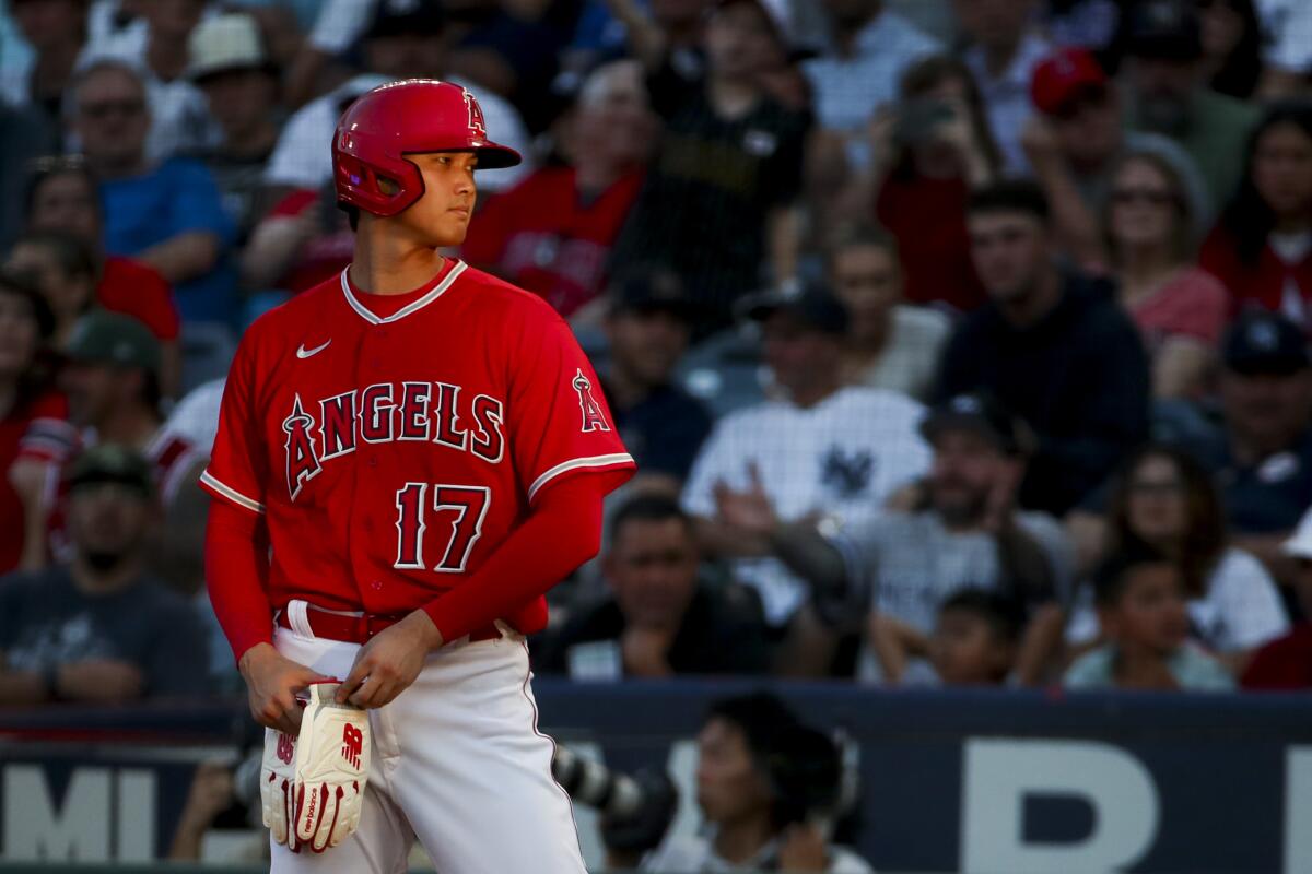 Angels designated hitter Shohei Ohtani stands on the field during a game against the Yankees.