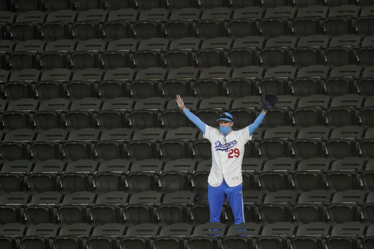 A Dodgers fan watches during batting practice before Game 3 of the NLCS on Wednesday.
