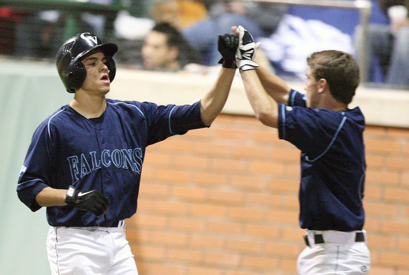 CV's Nick Diaz gets a high five from Joe Torres after scoring the second run against La Canada during a game at Stengel Field on Tuesday, March 4, 2014.