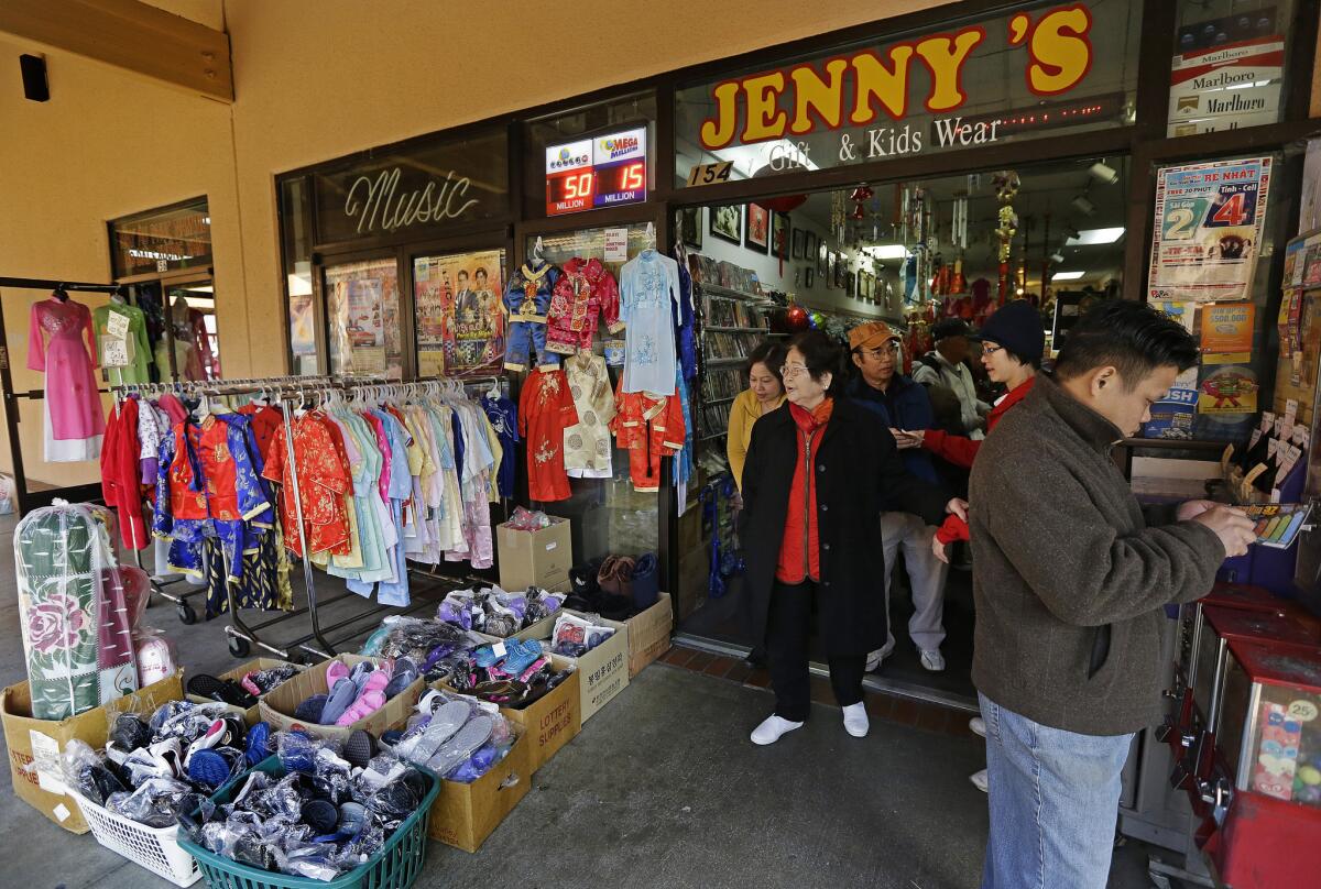 Customers crowd Jenny's Gift Shop in San Jose, where one of two winning tickets was sold for last month's $648-million Mega Millions jackpot drawing.