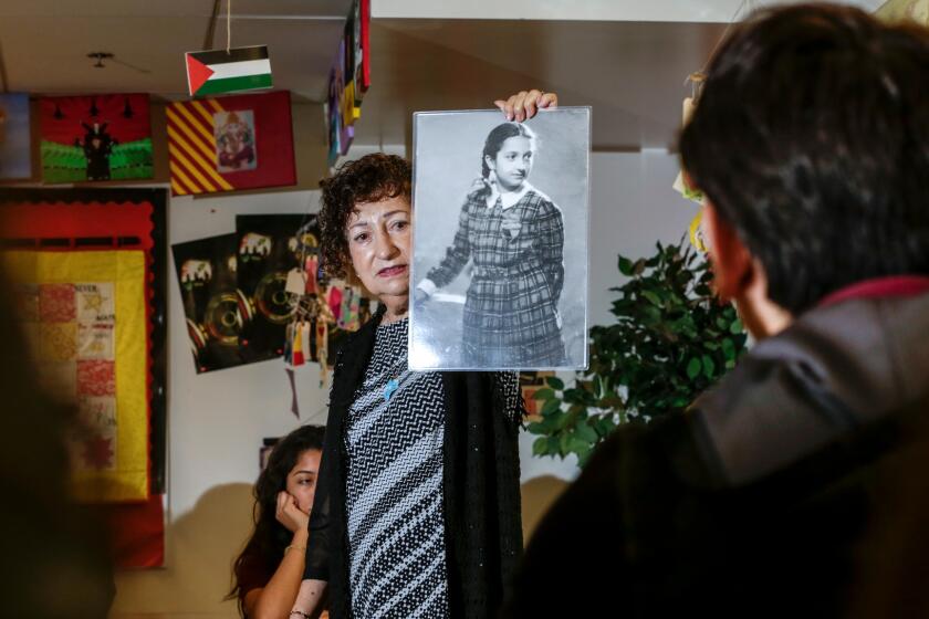 Gabriella Karin, who spent part of World War II in hiding from the Nazis, speaks to students at Animo Ralph Bunche High School about her experiences.