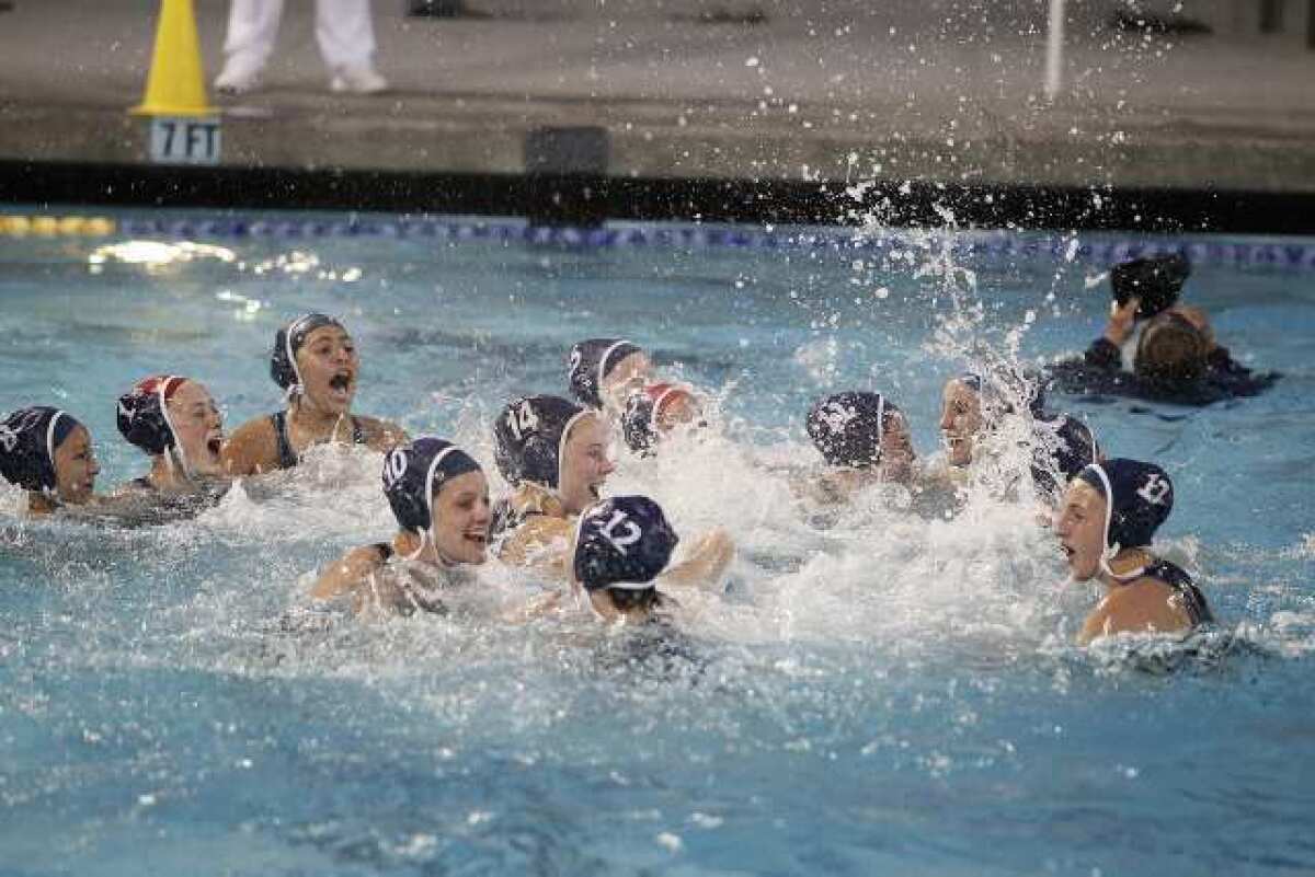The Crescenta Valley High girls' water polo team celebrates a 10-5 victory over Riverside Poly in the CIF Southern Section Division V championship game at the William Woollett Aquatics Center. It's the Falcons' first-ever CIF title.