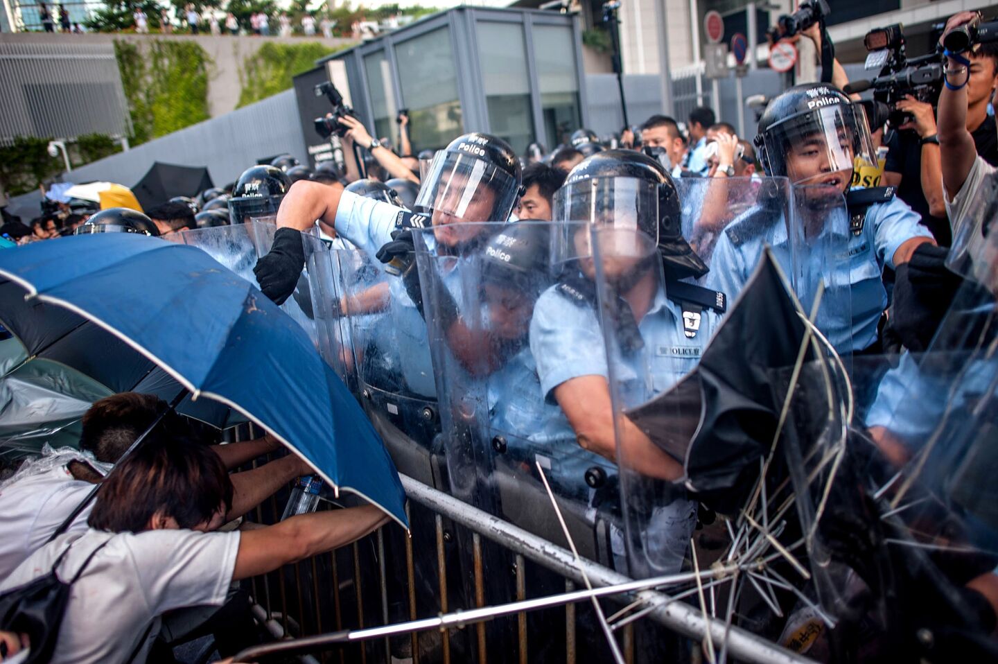Police officers reacts outside a government complex in Hong Kong, as thousands of students started a week-long boycott of classes in protest against Beijing's conservative framework for political reform in Hong Kong.