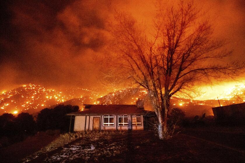 Embers burn along hillsides as the Mountain View Fire tears through the Walker community in Mono County, Calif., on Tuesday, Nov. 17, 2020. (AP Photo/Noah Berger)