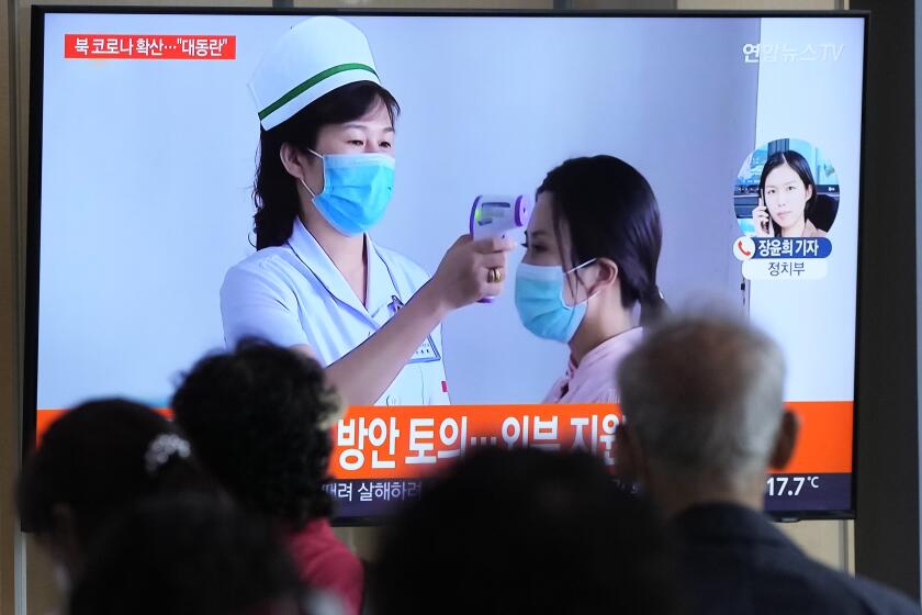 People watch a TV screen showing a news report about the COVID-19 outbreak in North Korea, at a train station in Seoul, South Korea, Saturday, May 14, 2022. North Korea on Saturday reported 21 new deaths and 174,440 more people with fever symptoms as the country scrambles to slow the spread of COVID-19 across its unvaccinated population. (AP Photo/Ahn Young-joon)