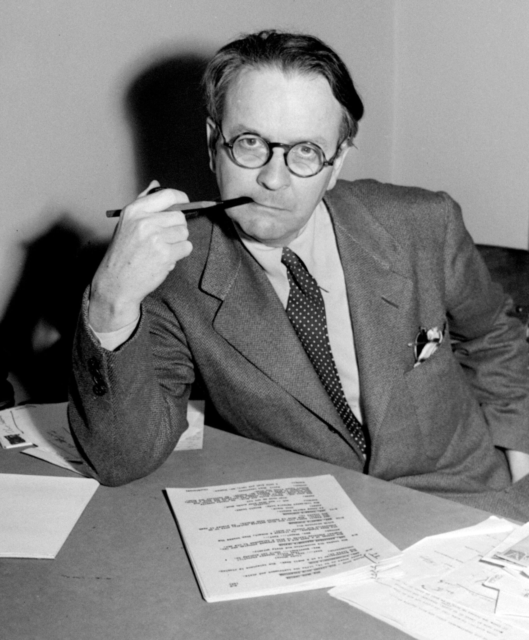 Raymond Chandler leans on a desk in 1946.
