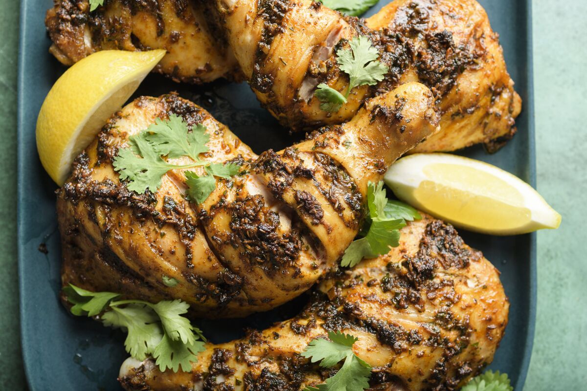 This image released by Milk Street shows a recipe for Moroccan Inspired Roasted Spiced Chicken. (Milk Street via AP)