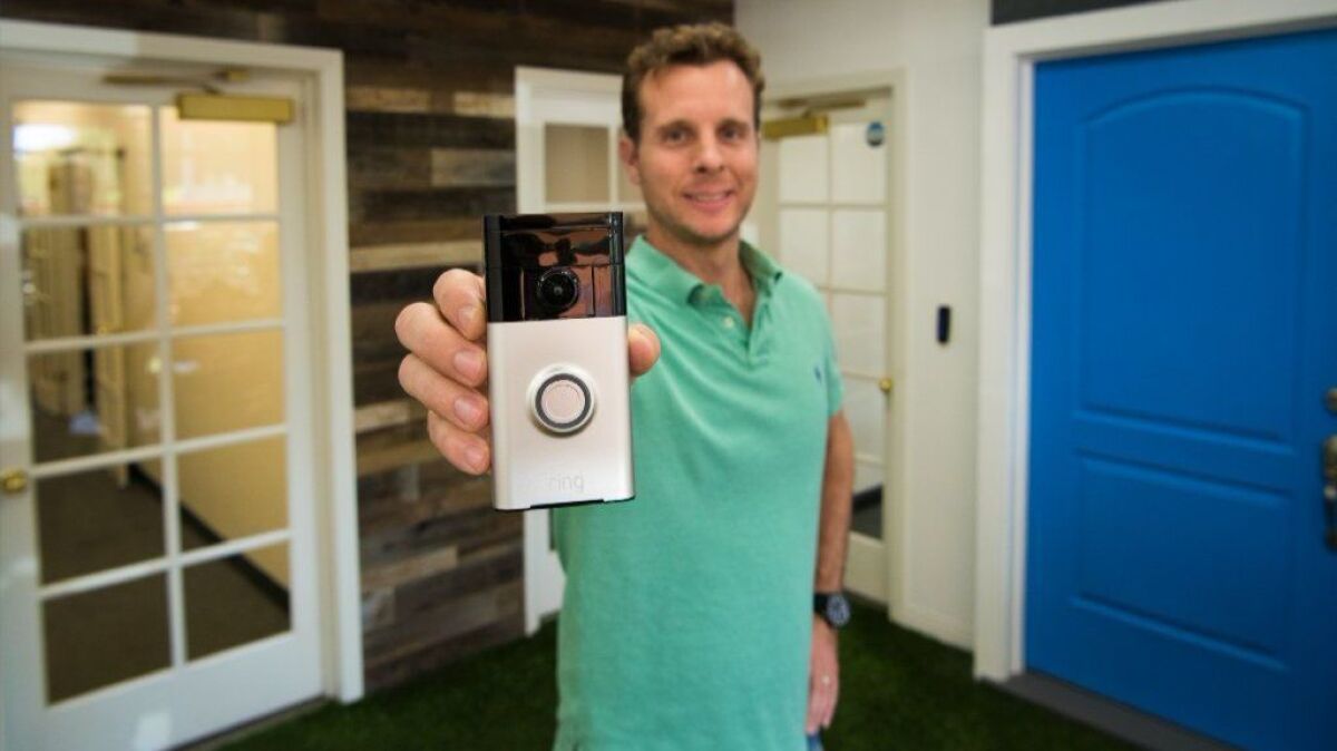 Ring founder and Chief Executive Jamie Siminoff holds a Ring video doorbell in the lobby of Ring's Santa Monica office.