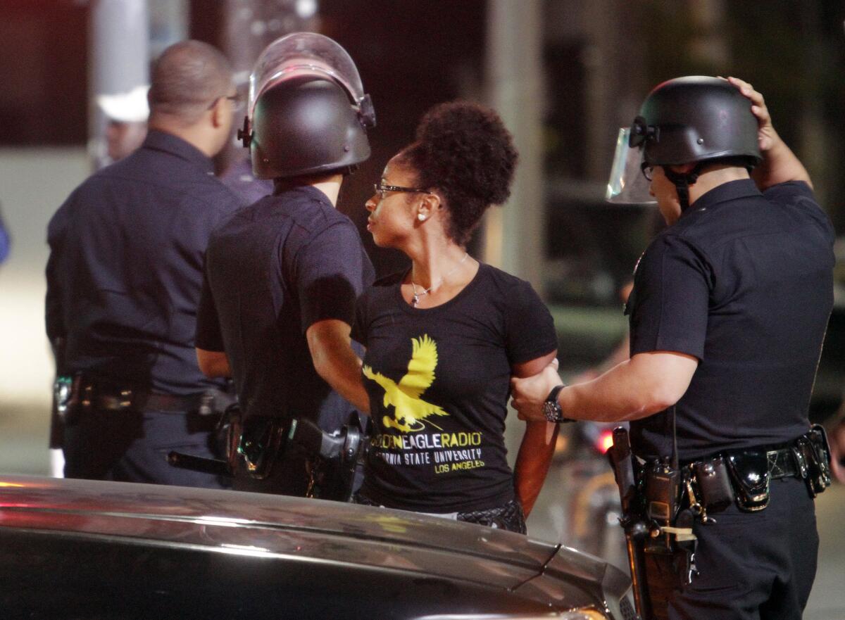 L.A. police officers arrest a protester at the intersection of Crenshaw Boulevard and Adams Boulevard in Los Angeles.