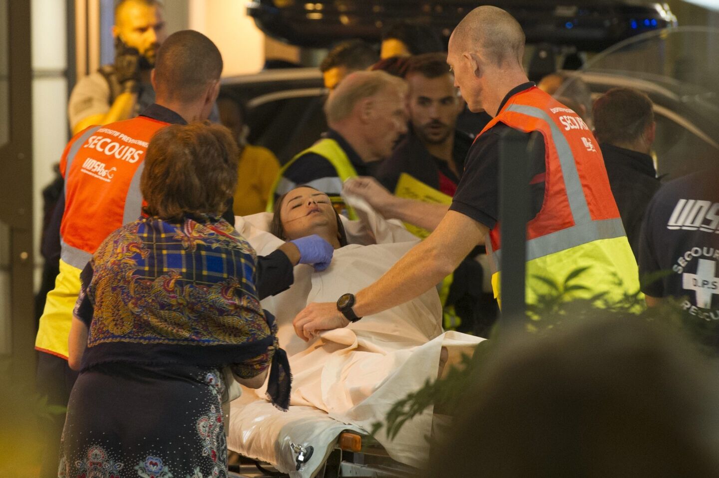 Emergency workers tend to a woman injured in the truck attack.