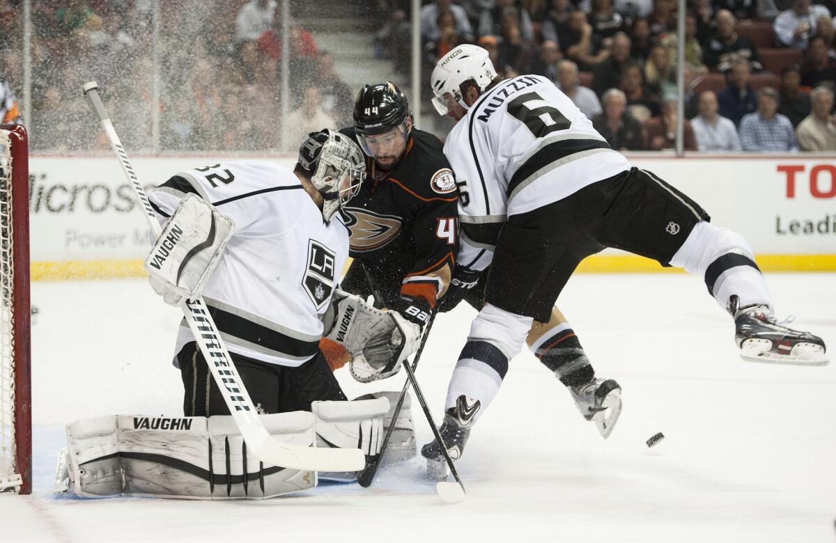 Ducks' Nate Thompson can't get the puck past the Kings' Jake Muzzin and Jonathan Quick on Wednesday night.