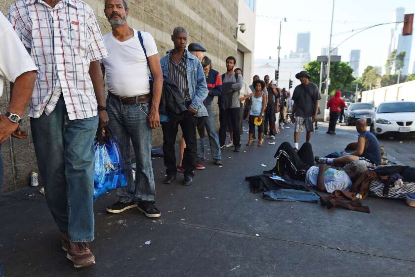 People wait for a meal outside the Midnight Mission on Skid Row Sept. 23, the week that L.A. officials declared a homelessness "state of emergency" and pledged to spend $100 million to tackle the crisis.