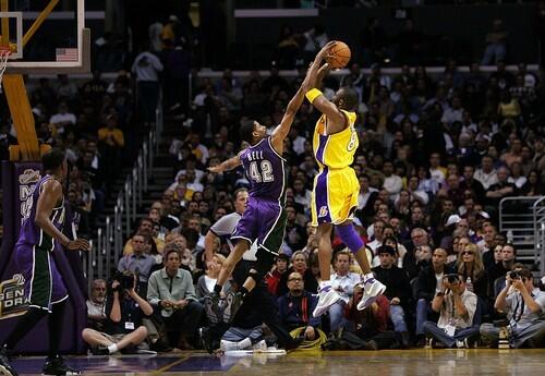 Kobe Bryant goes up for a 3-point shot as the Milwaukee Bucks' Charlie Bell defends.