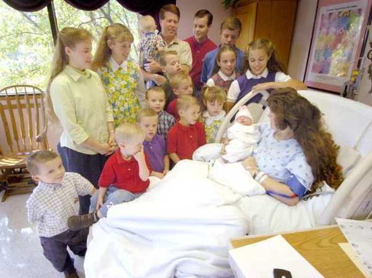 The Duggars in 2005, before they continued adding to their big family. The cost of raising a child born last year will be $234,900 until age 17.
