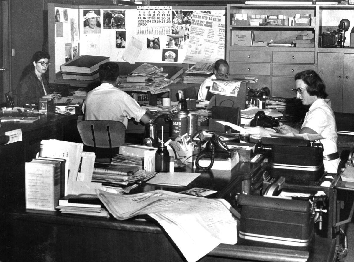 Jeanne Keevil, right, in the newsroom of the Globe-Herald.