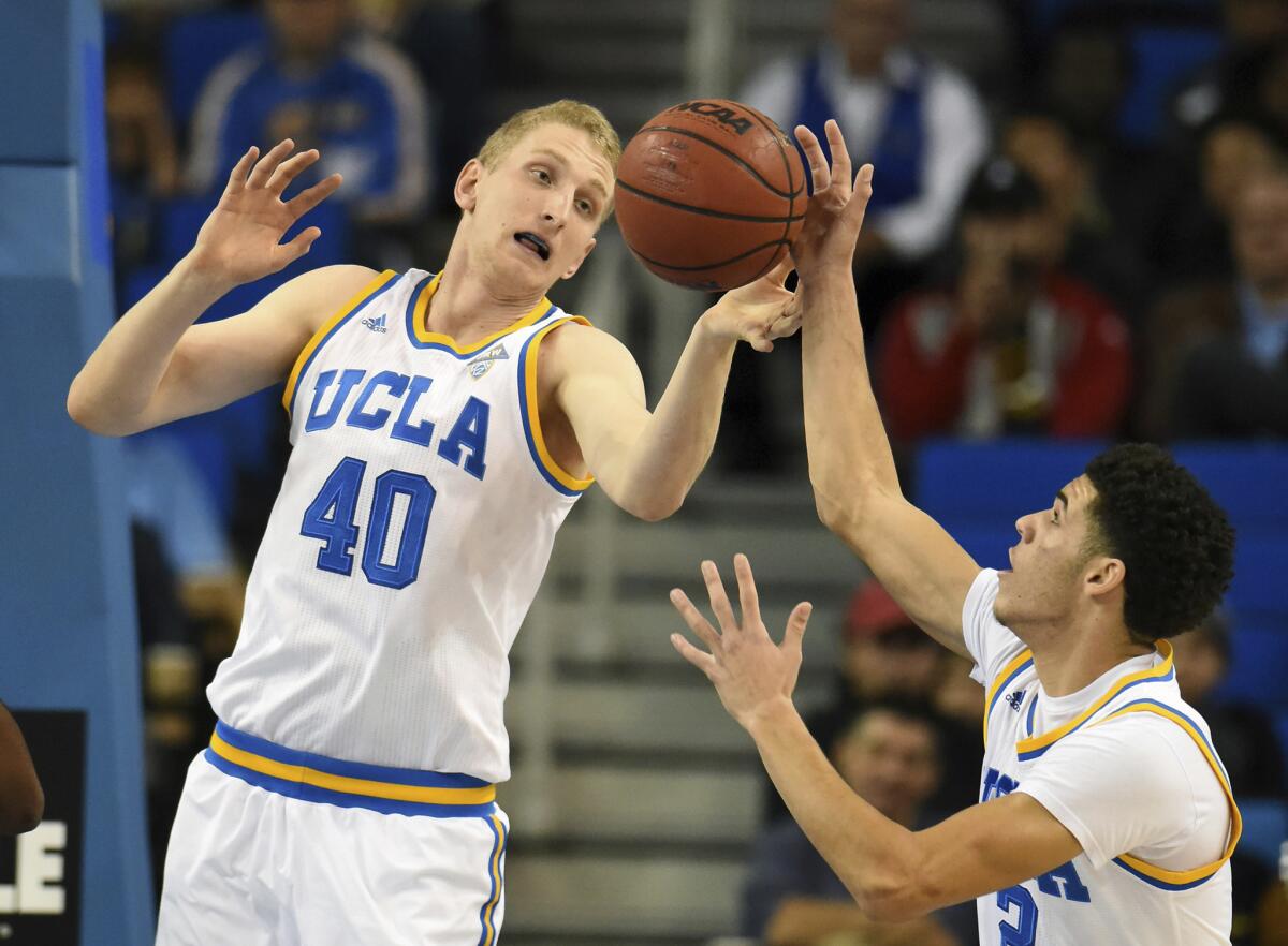 UCLA forward Thomas Welsh (40) and Lonzo Ball (2) go for a rebound against Long Beach State during the first half on Nov. 20.