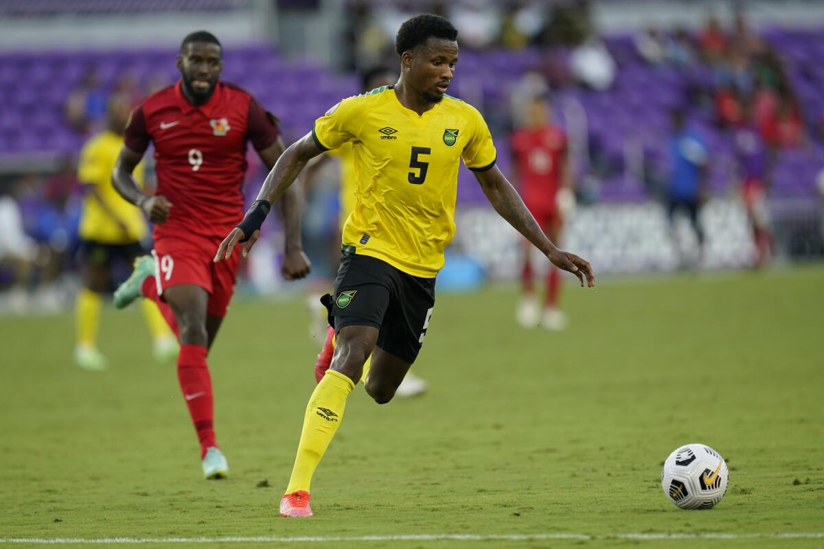 Jamaica defender Alvas Powell moves the ball ahead of Guadeloupe forward Raphael Mirval.