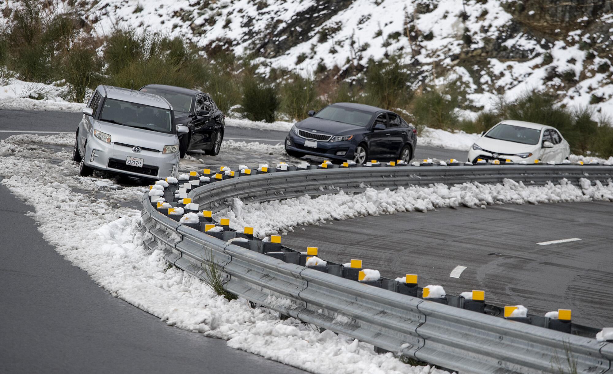 Vehicles that were abandoned, stuck or wrecked along the highway in Crestline, Calif., after a snowstorm.