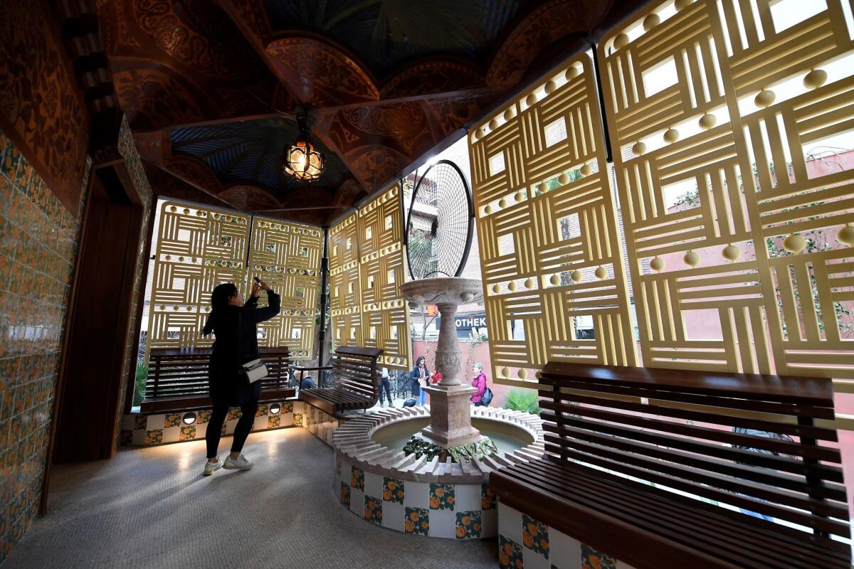 A woman takes a picture inside the "Casa Vicens," designed by Spanish architect Antoni Gaudi.