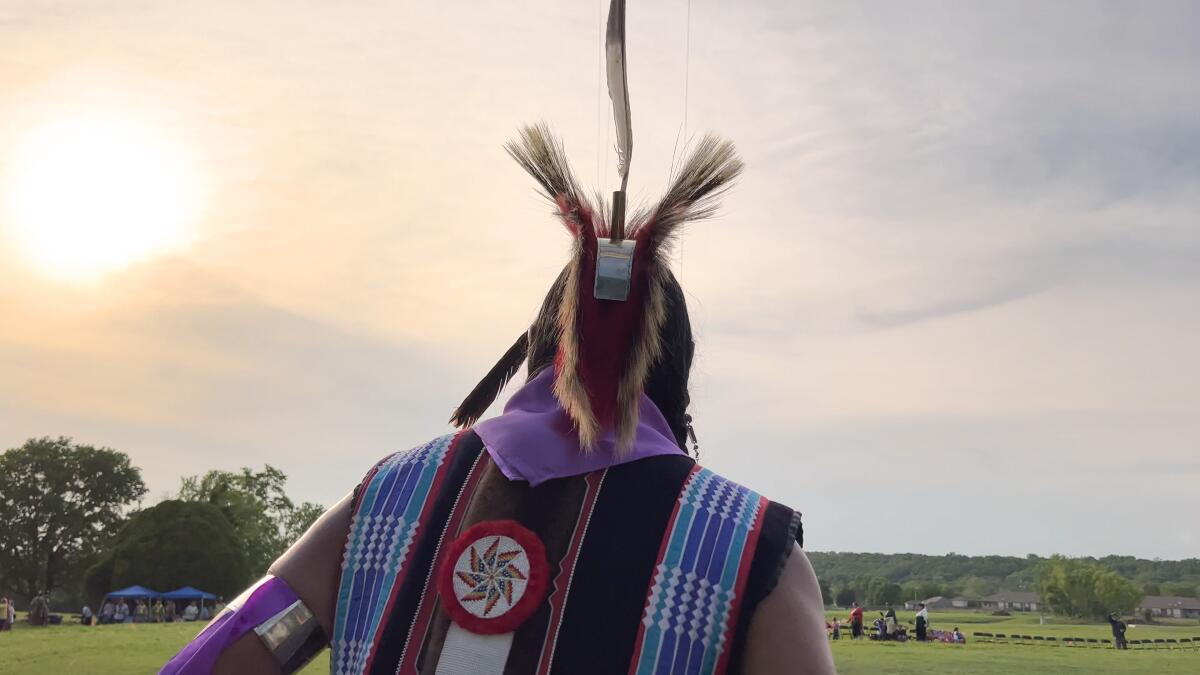 An Osage dancer seen from behind.