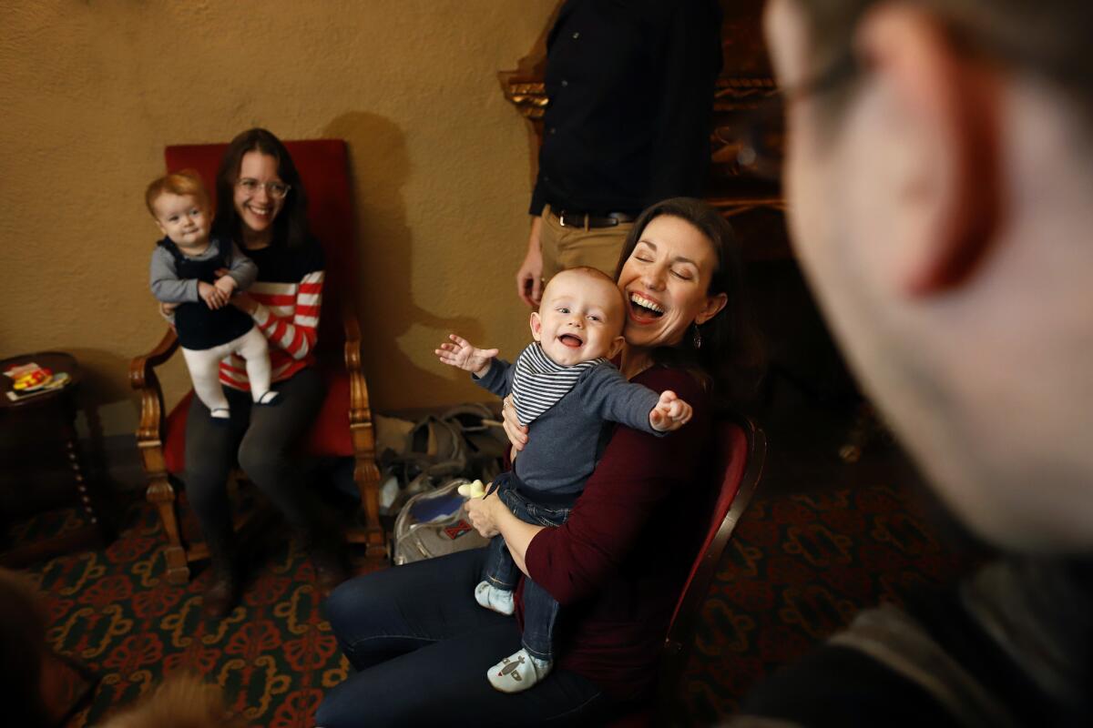 Liz Hayes, center, holds baby Sean with the other infant actors of "The Ferryman" at the Bernard B. Jacobs Theatre in New York. At left, Christine Scarfuto with daughter Annie.