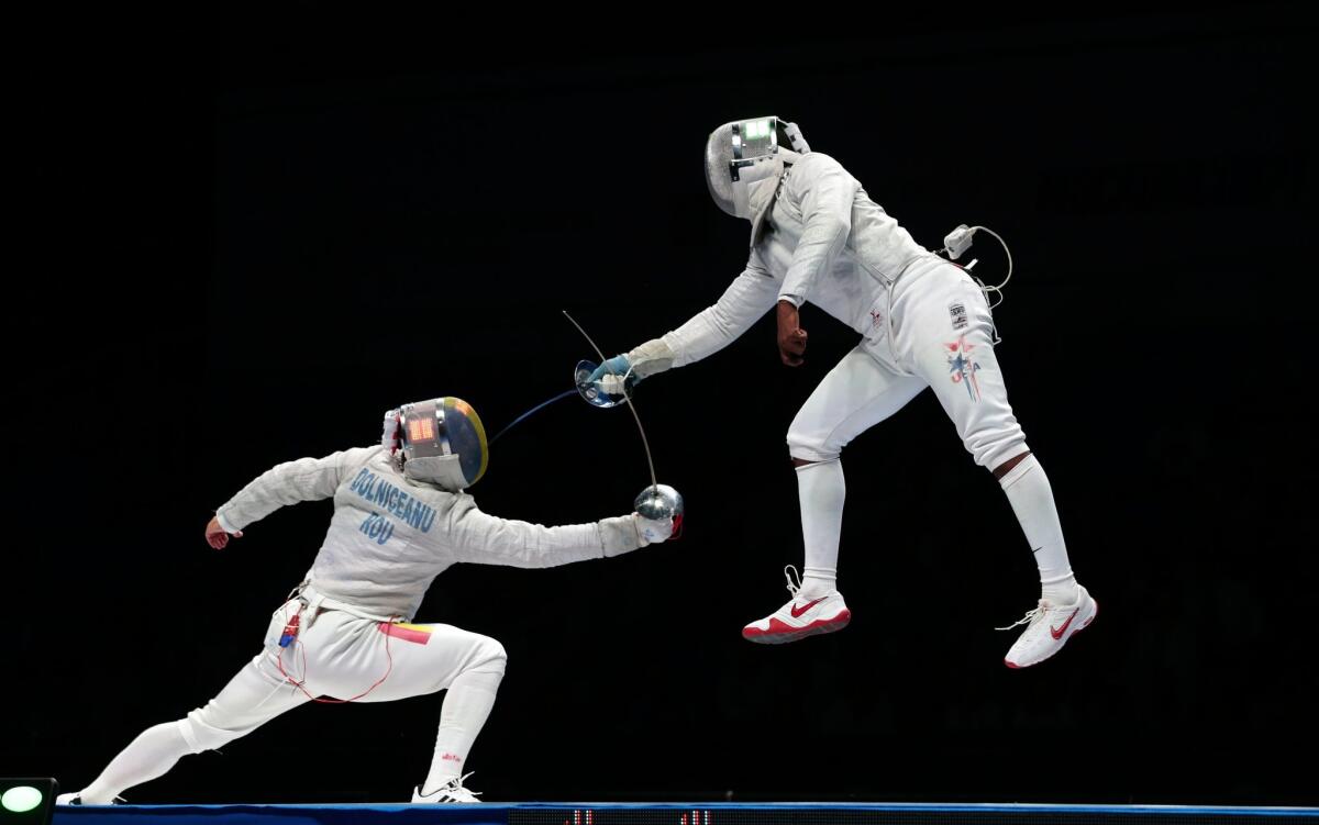 Tiberiu Dolniceanu of Romania, left, and Daryl Homer of the U.S. compete in the fencing World championships last year.