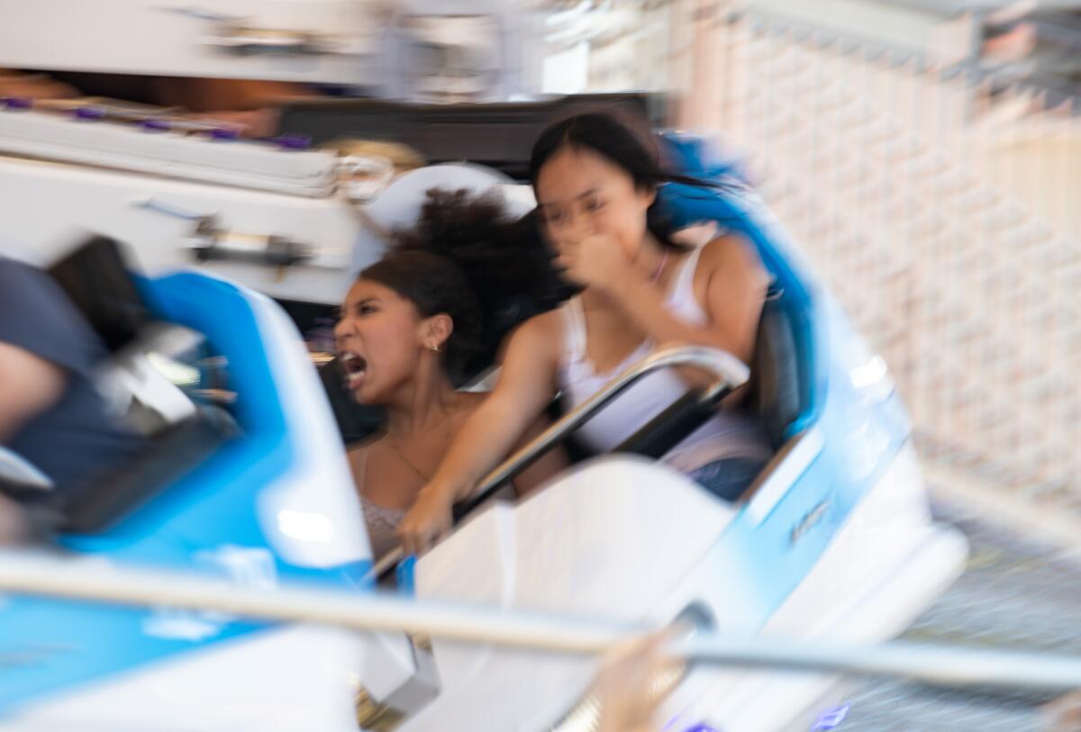 Fairgoers cling to their seats on a carnival ride at the OC Fair.