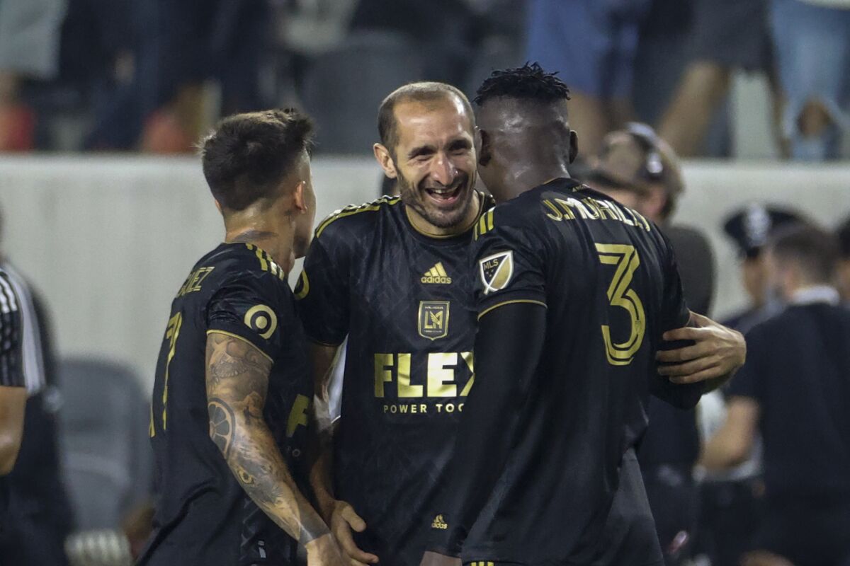 LAFC defender Giorgio Chiellini, center celebrates with teammates after a win over the Seattle Sounders in July.