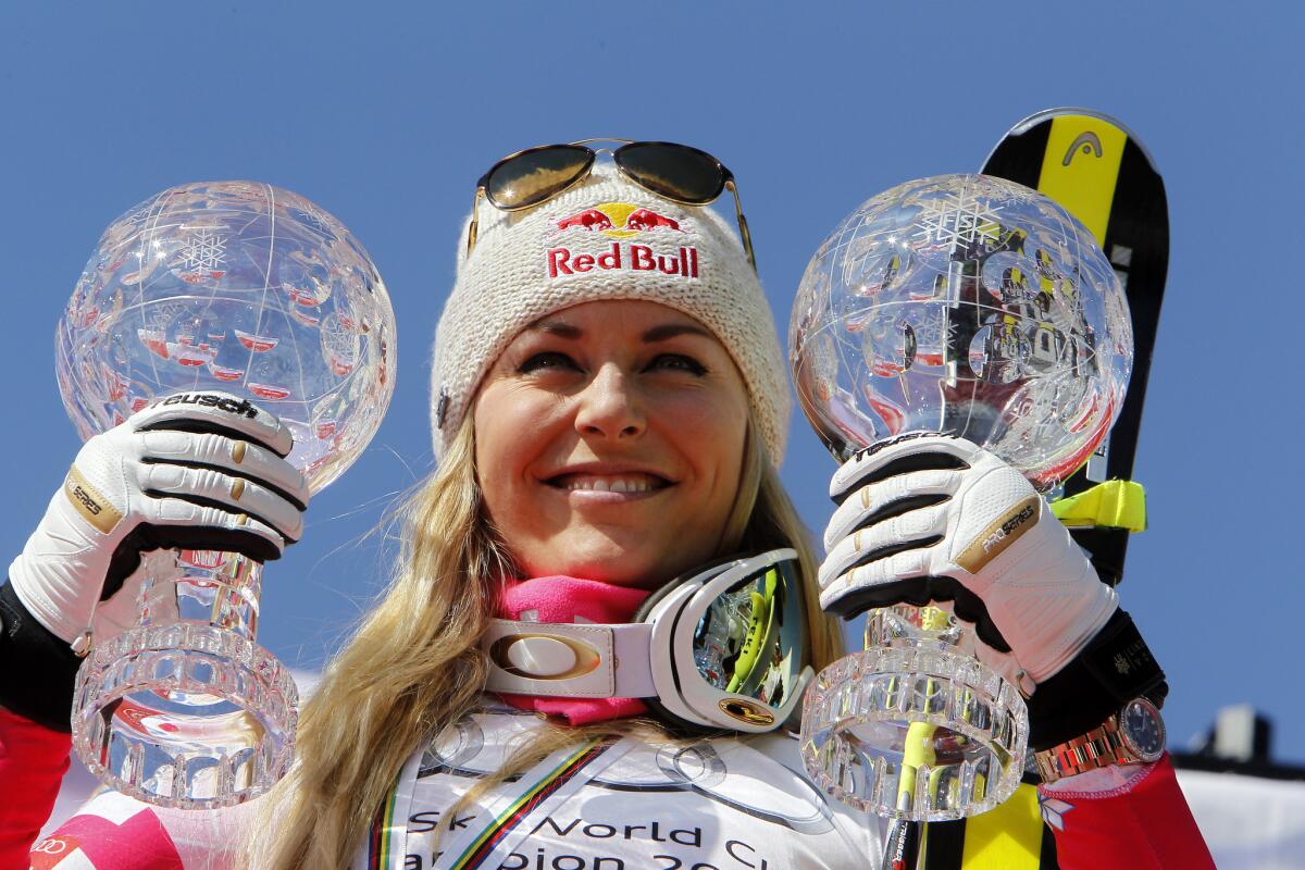 Skier Lindsey Vonn holds her crystal ball trophies after winning the overall women's super-G and downhill World Cup titles at the FIS Alpine Ski World Cup finals on Thursday in Meribel, France.