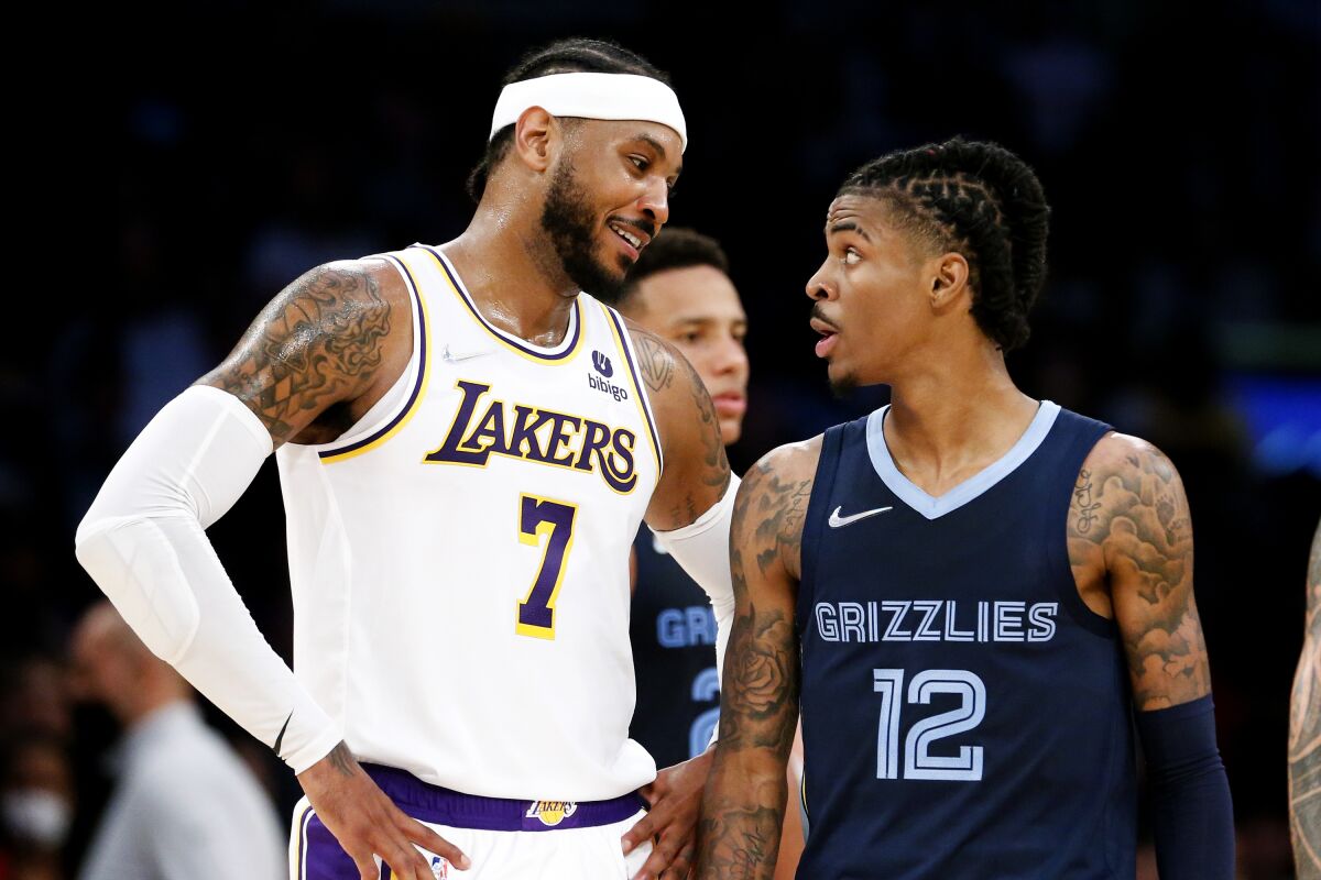 Lakers forward Carmelo Anthony, left, talks with Memphis Grizzlies guard Ja Morant.