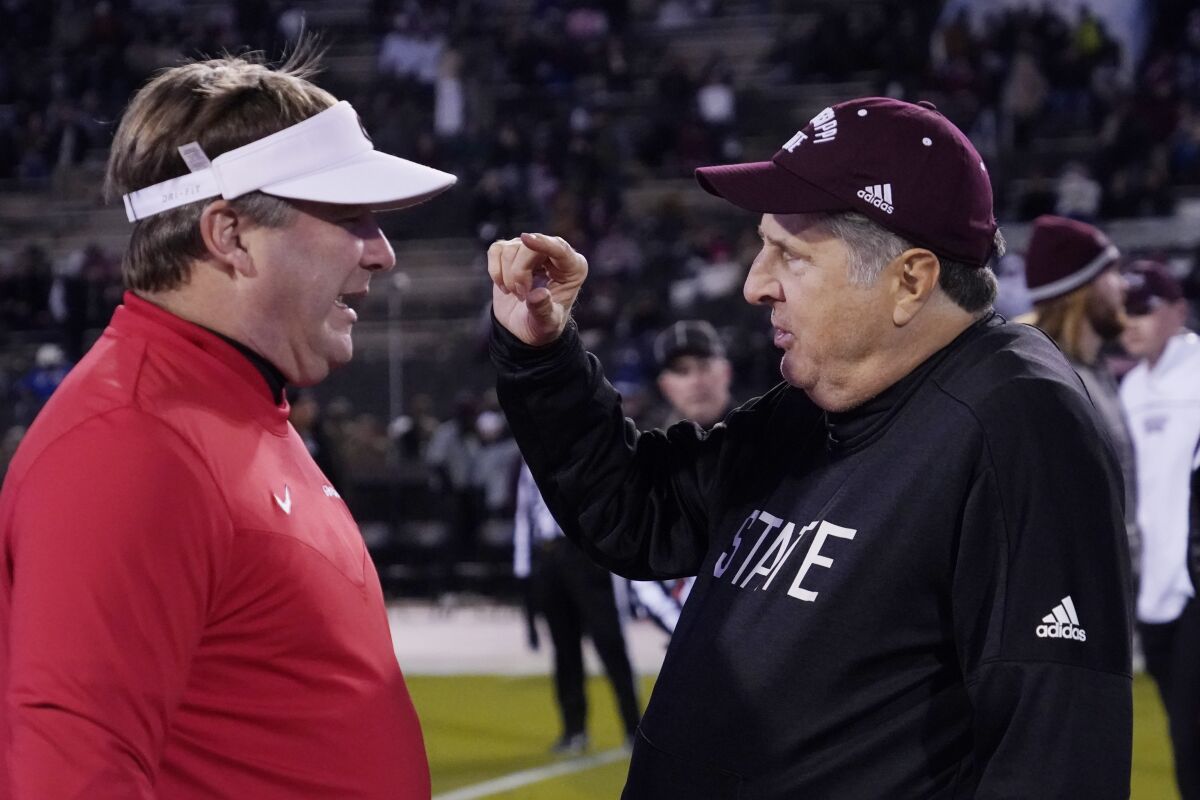 Georgia coach Kirby Smart, left, and Mississippi State coach Mike Leach talk before a game on Nov. 12.