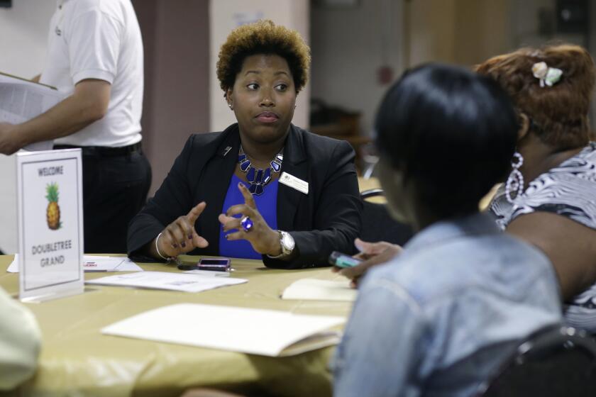 Natalie Parker, director of human resources at the Doubletree Grand in Miami, left, talks with job applicants during a job fair at the Hospitality Institute on Jan. 23.