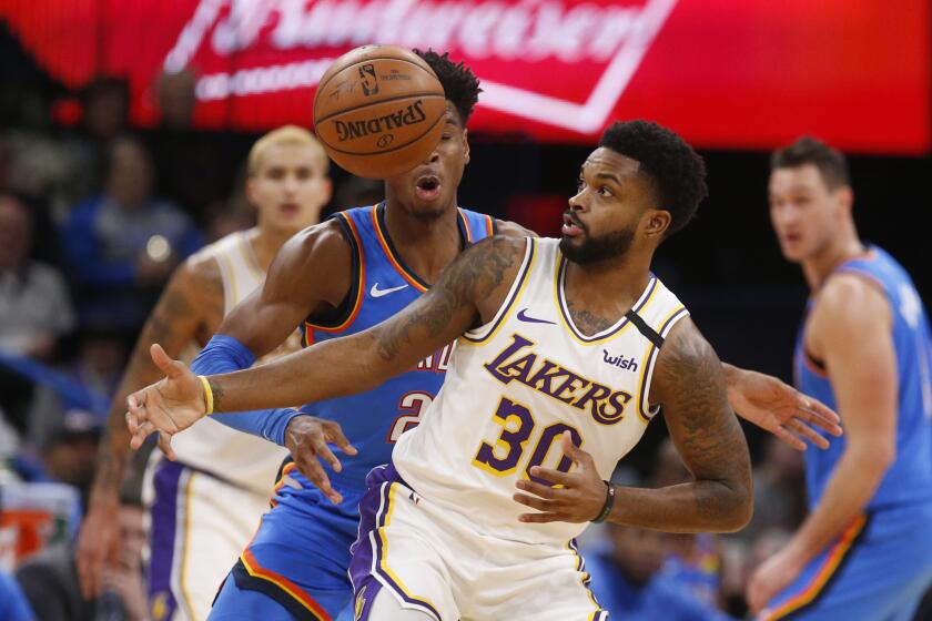 Oklahoma City Thunder guard Shai Gilgeous-Alexander (2) knocks the ball away from Los Angeles Lakers guard Troy Daniels (30) during the second half of an NBA basketball game Saturday, Jan. 11, 2020, in Oklahoma City. (AP Photo/Sue Ogrocki)