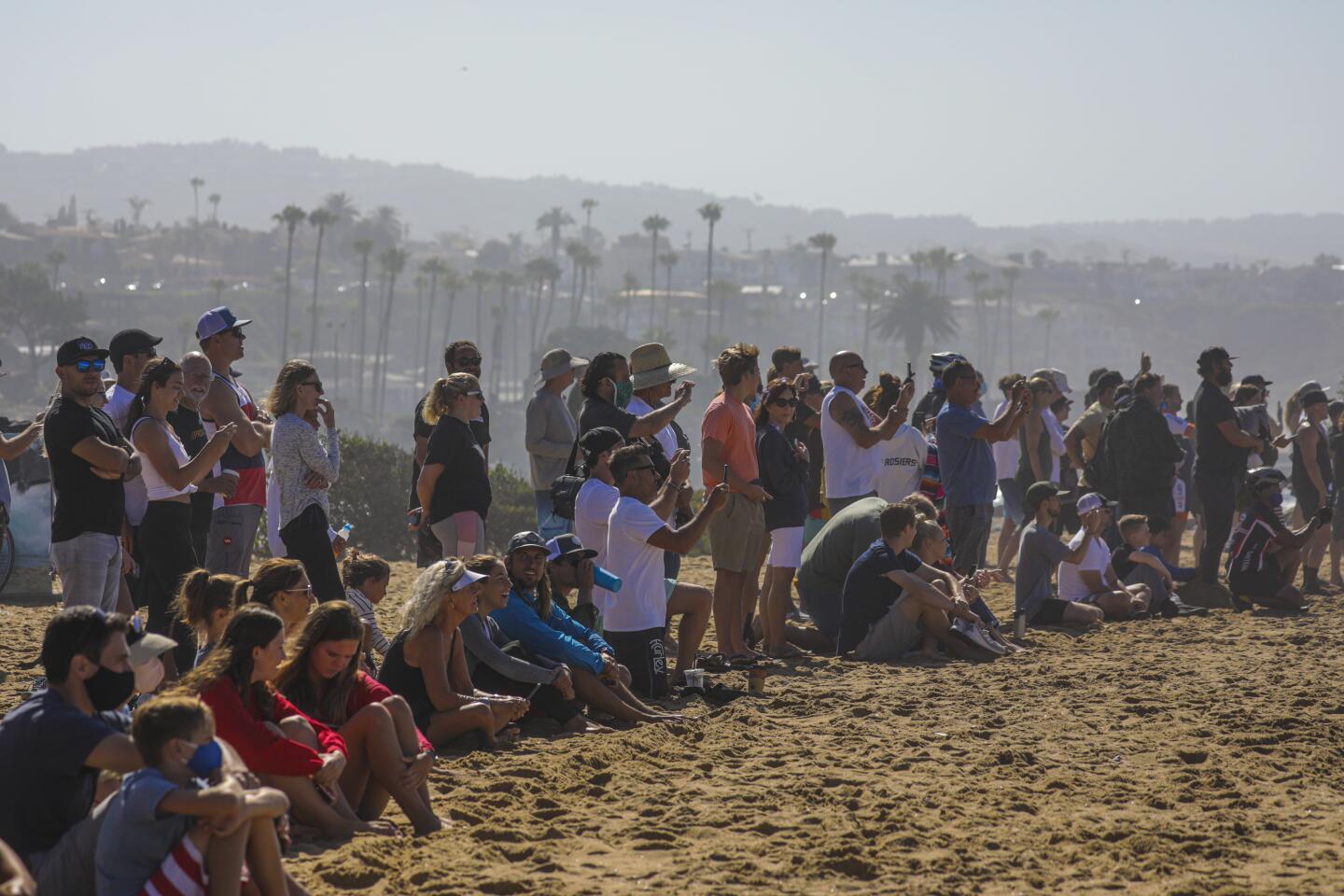 Spectators along the Wedge in Newport Beach, a surf spot, on July 4.