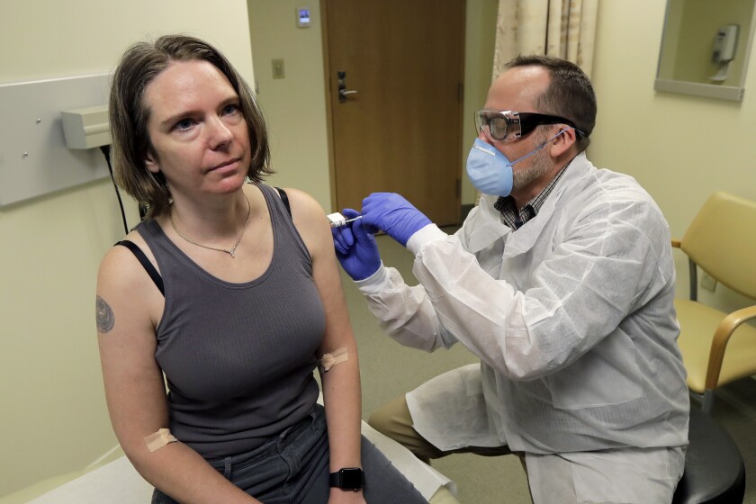 A volunteer receives a shot of Moderna's experimental coronavirus vaccine.