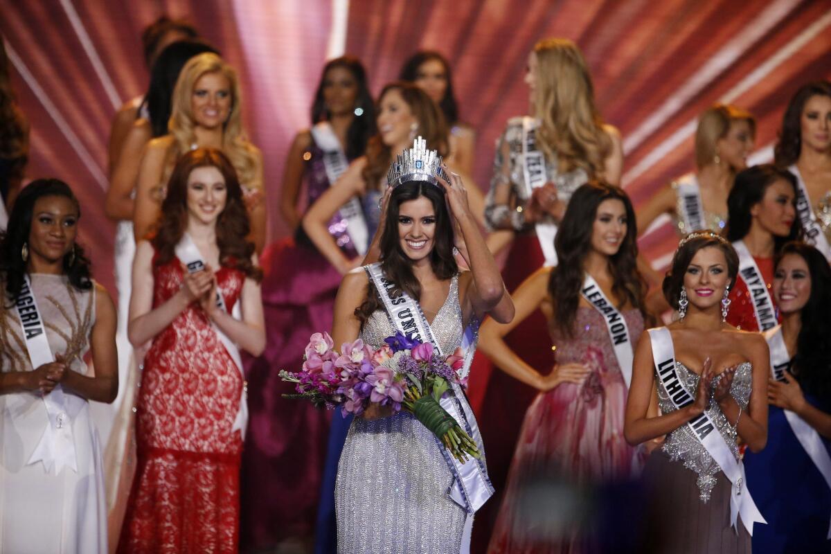Miss Colombia Paulina Vega (center) is crowned Miss Universe 2014 at the 2014 Miss Universe Final at the FIU Arena in Miami on Jan. 25, 2015.