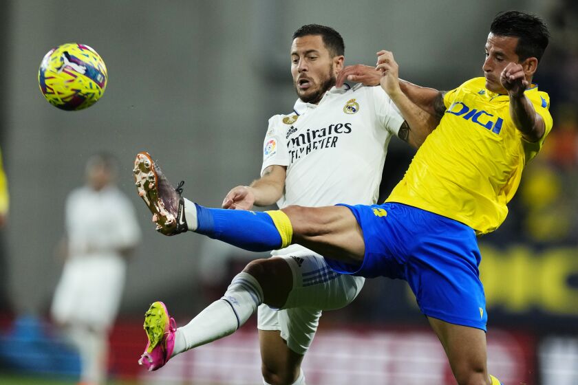 FILE - Real Madrid's Eden Hazard, centre, and Cadiz's Luis Hernandez challenge for the ball during the Spanish La Liga soccer match between Cadiz CF and Real Madrid at the Nuevo Mirandilla stadium in Cadiz, Spain, Saturday, April 15, 2023. The Spanish league reaches its finish with six teams vying to not become the last side to be relegated to the second division. Cadiz, Getafe and Valencia each have 41 points. (AP Photo/Jose Breton, File)