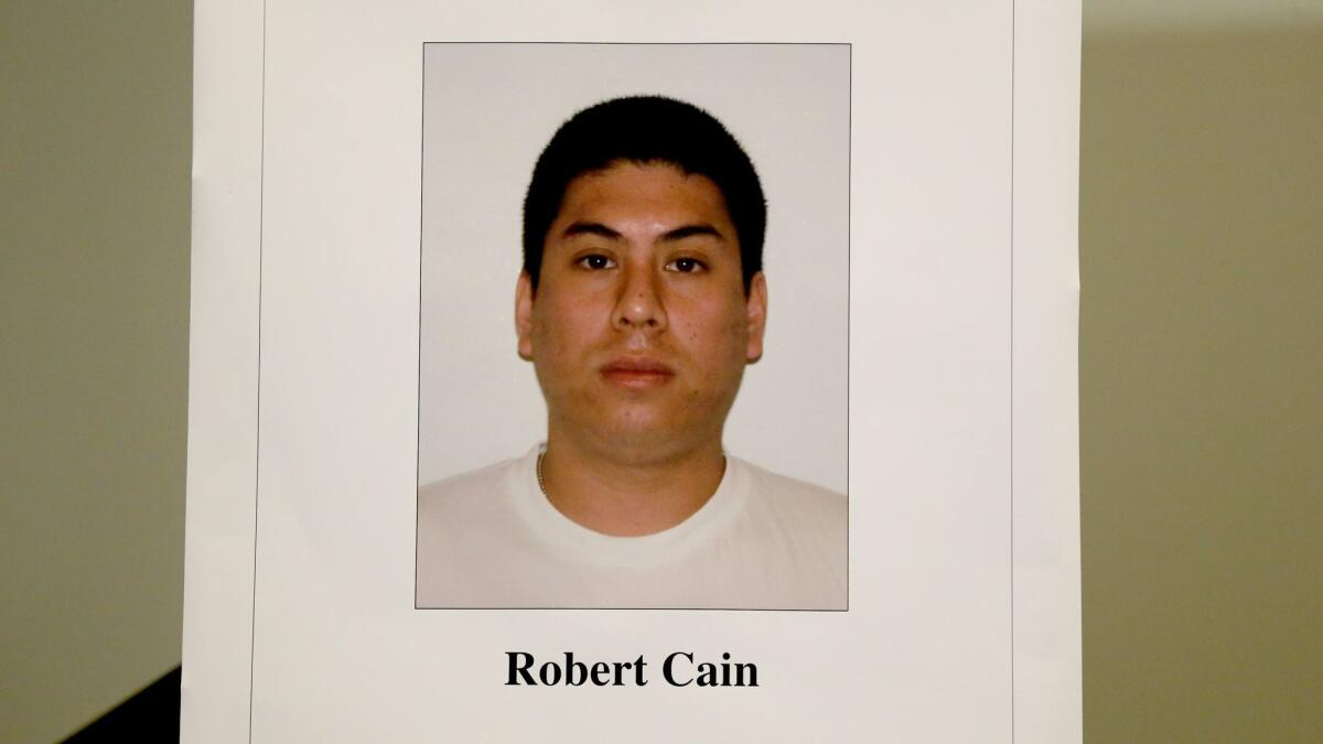 Photo of Officer Robert Cain on display at an LAPD news conference, where Los Angeles Police Chief Charlie Beck announced Cain was under arrest on suspicion of statutory rape of a 15-year-old cadet.