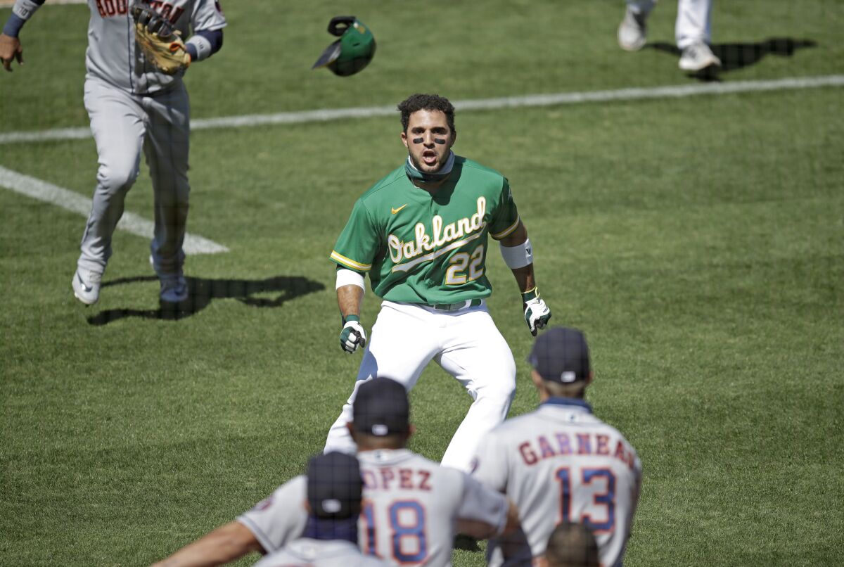 Oakland Athletics' Ramon Laureano (22) charges the Houston Astros dugout after being hit by a pitch thrown by Humberto Castellanos in the seventh inning of a baseball game Sunday, Aug. 9, 2020, in Oakland, Calif. (AP Photo/Ben Margot)