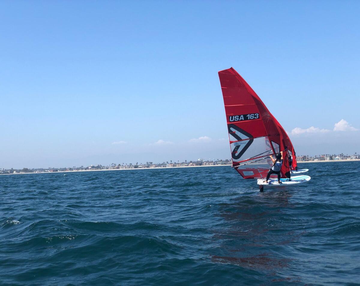 A competitor adjusts a sail in Long Beach during the West Marine U.S. Open Sailing Series Friday.
