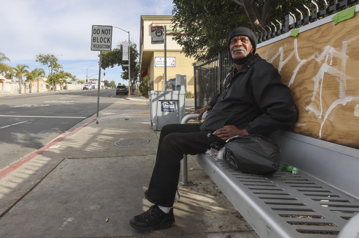 Former area resident Leonard Price sits on a bench on Market Street in the Mt. Hope neighborhood Wednesday.