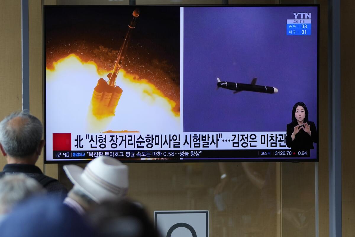 People watch a TV screen showing a news program reporting about North Korea's long-range cruise missiles tests with images in Seoul, South Korea, Monday, Sept. 13, 2021. North Korea says it successfully test fired newly developed long-range cruise missiles over the weekend, its first known testing activity in months, underscoring how it continues to expand its military capabilities amid a stalemate in nuclear negotiations with the United States. The letters read, "The North newly test-fired long-range cruise missiles." (AP Photo/Lee Jin-man)